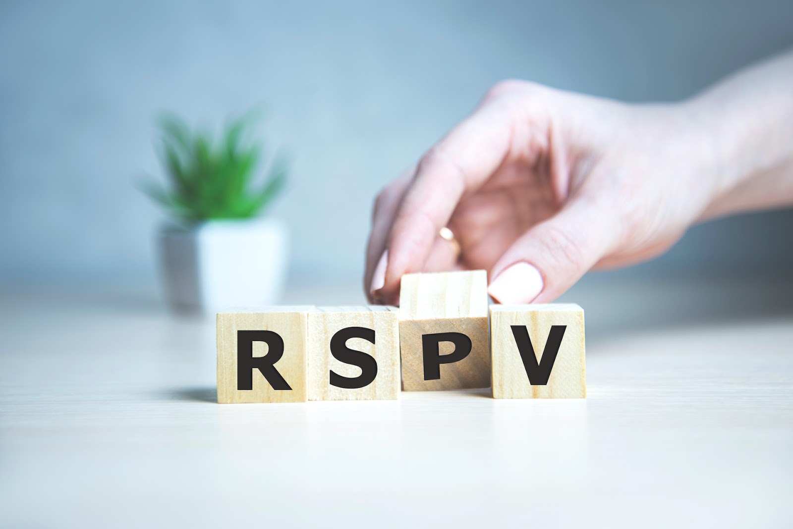 hand moving RSVP letters