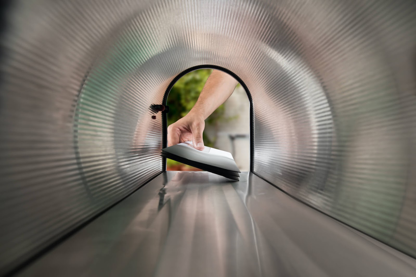 Hand taking invitation out of mailbox