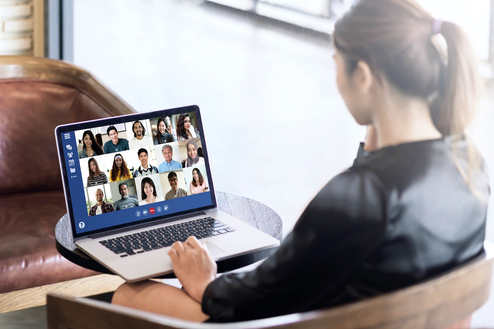 Woman in a zoom meeting with several people