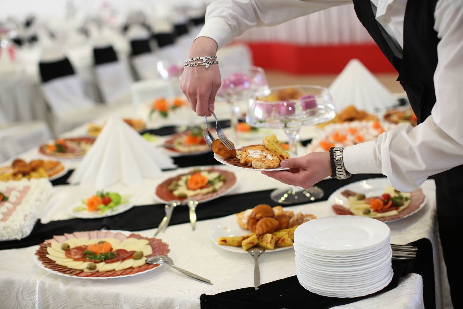 Someone dishing up from a buffet