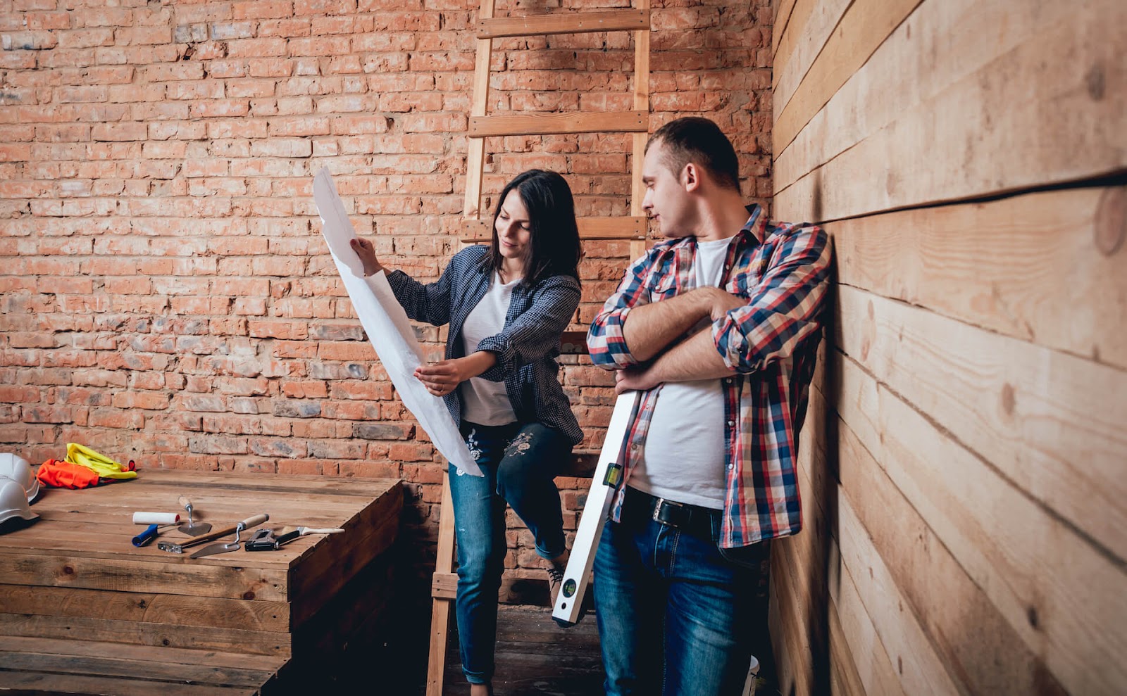 Couple looking at plans to build a tiny house