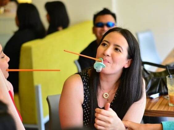 Women playing Pass the Pacifier at a baby shower