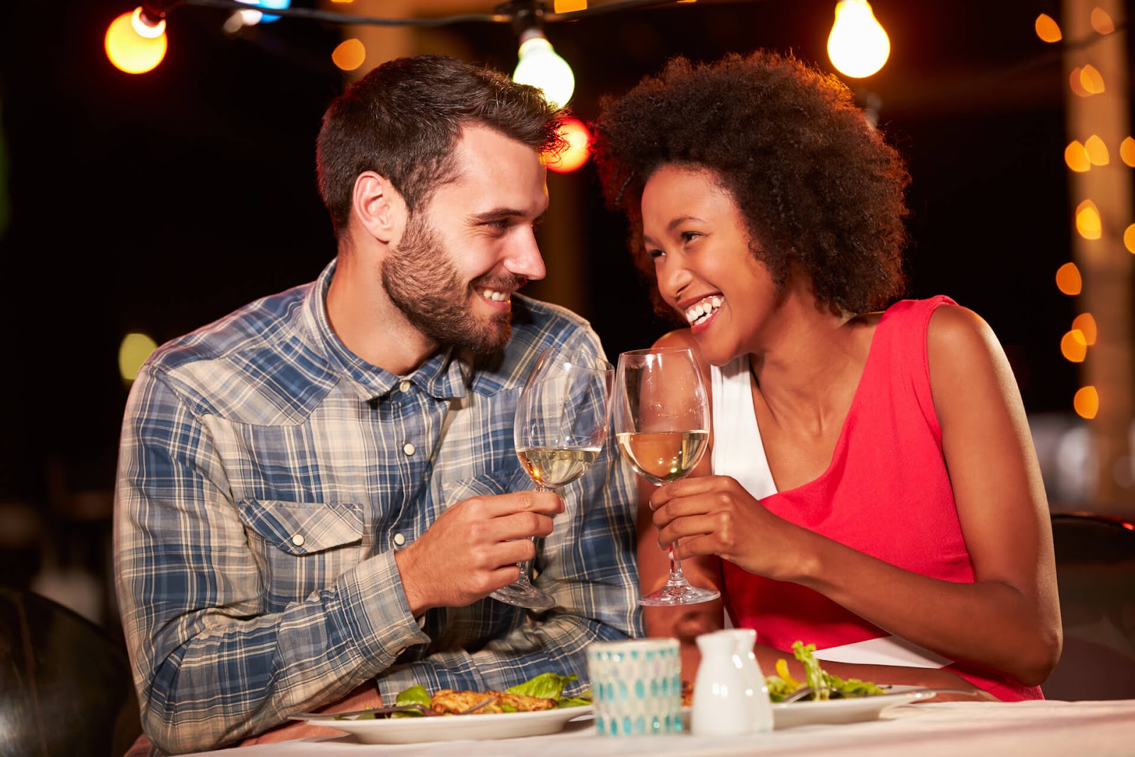 Man and woman eating at a restaurant and having fun