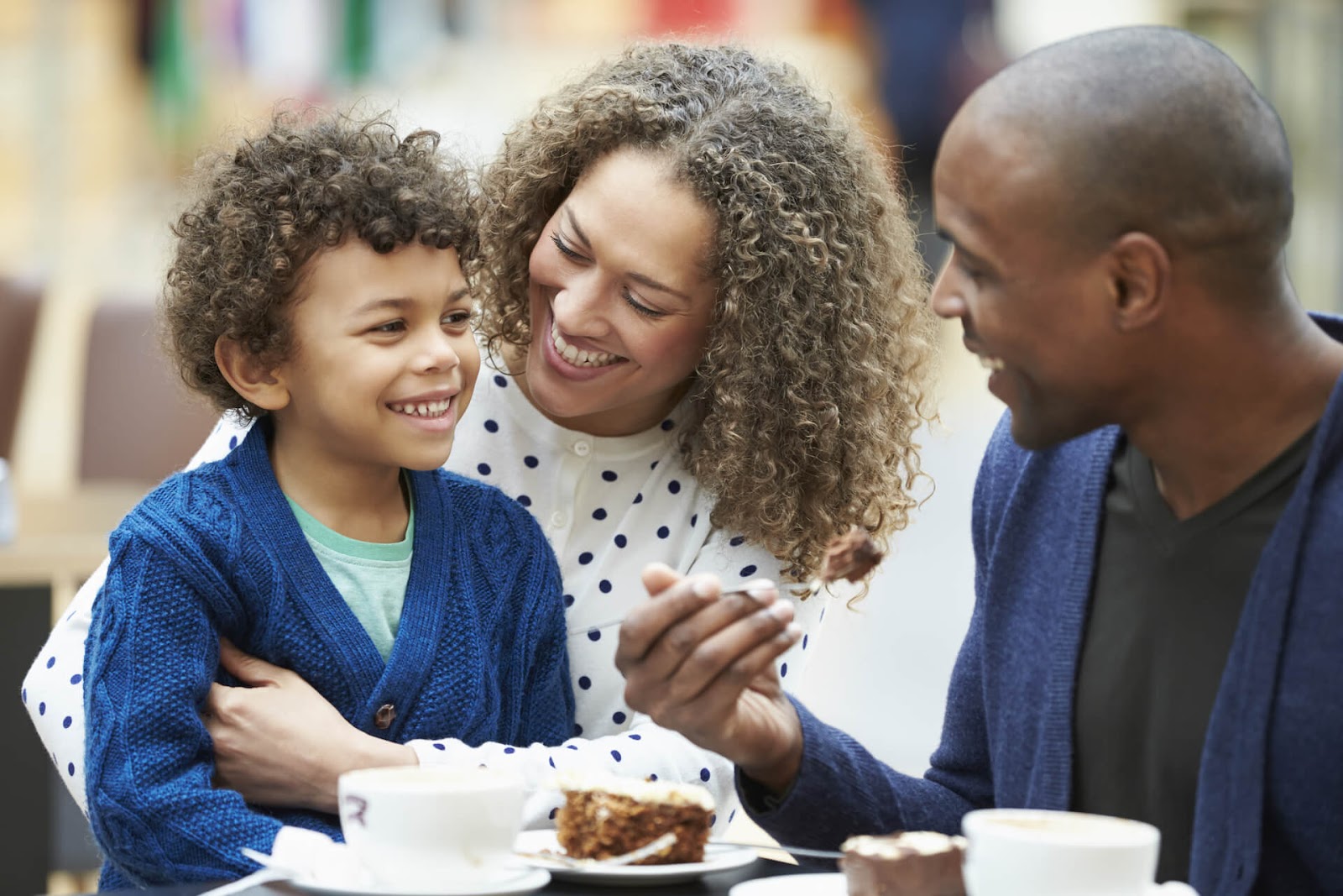 Family talking and eating cake together
