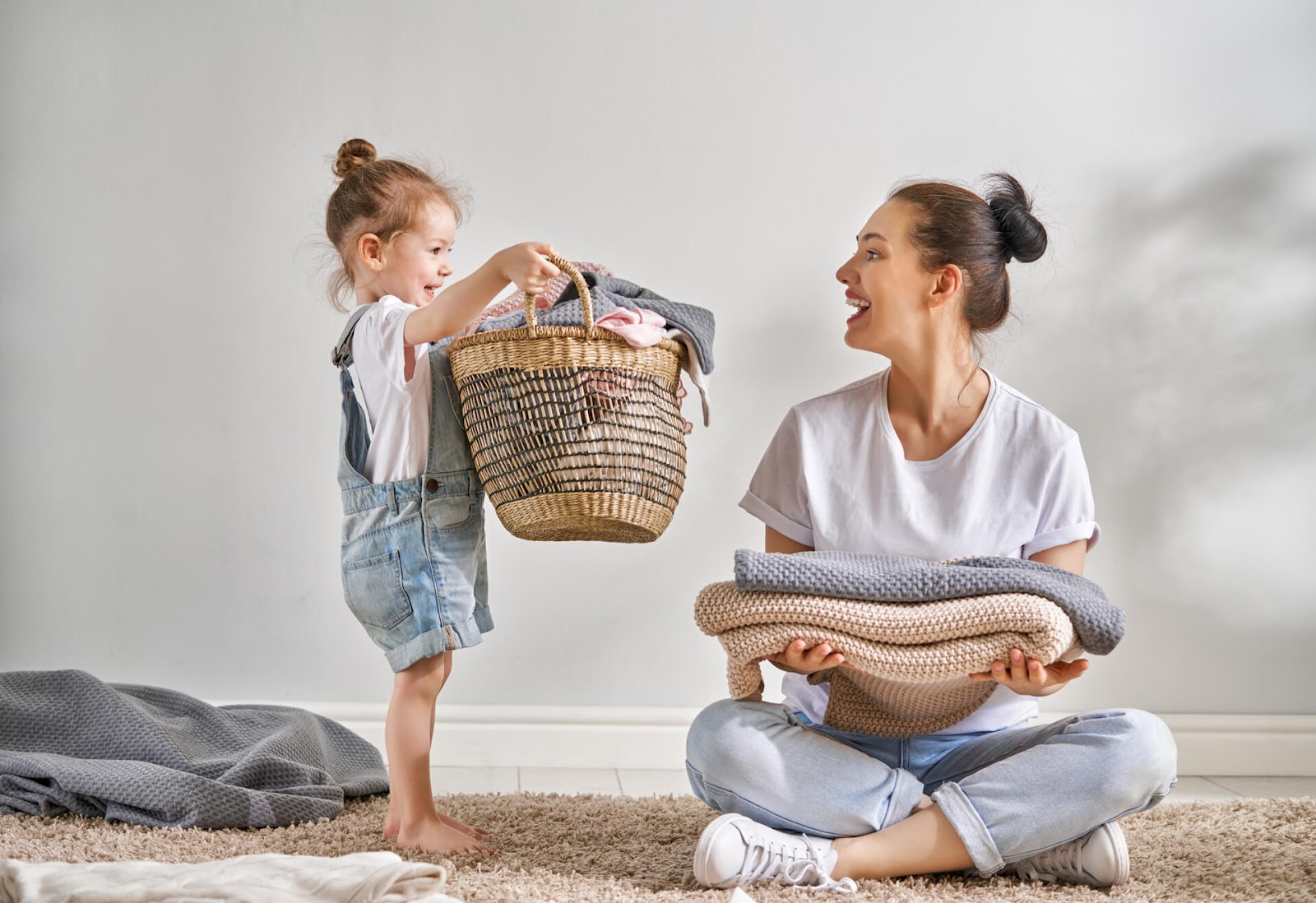 Mom enjoying laundry with her daughter