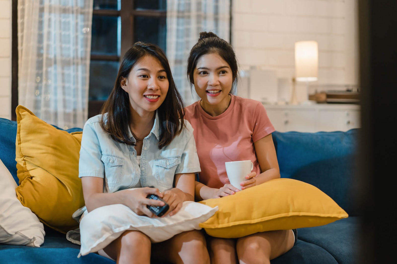 Two woman watching a movie together