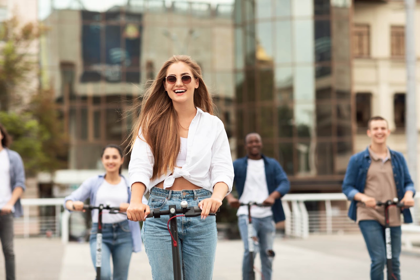 Woman scootering around a city with her friends
