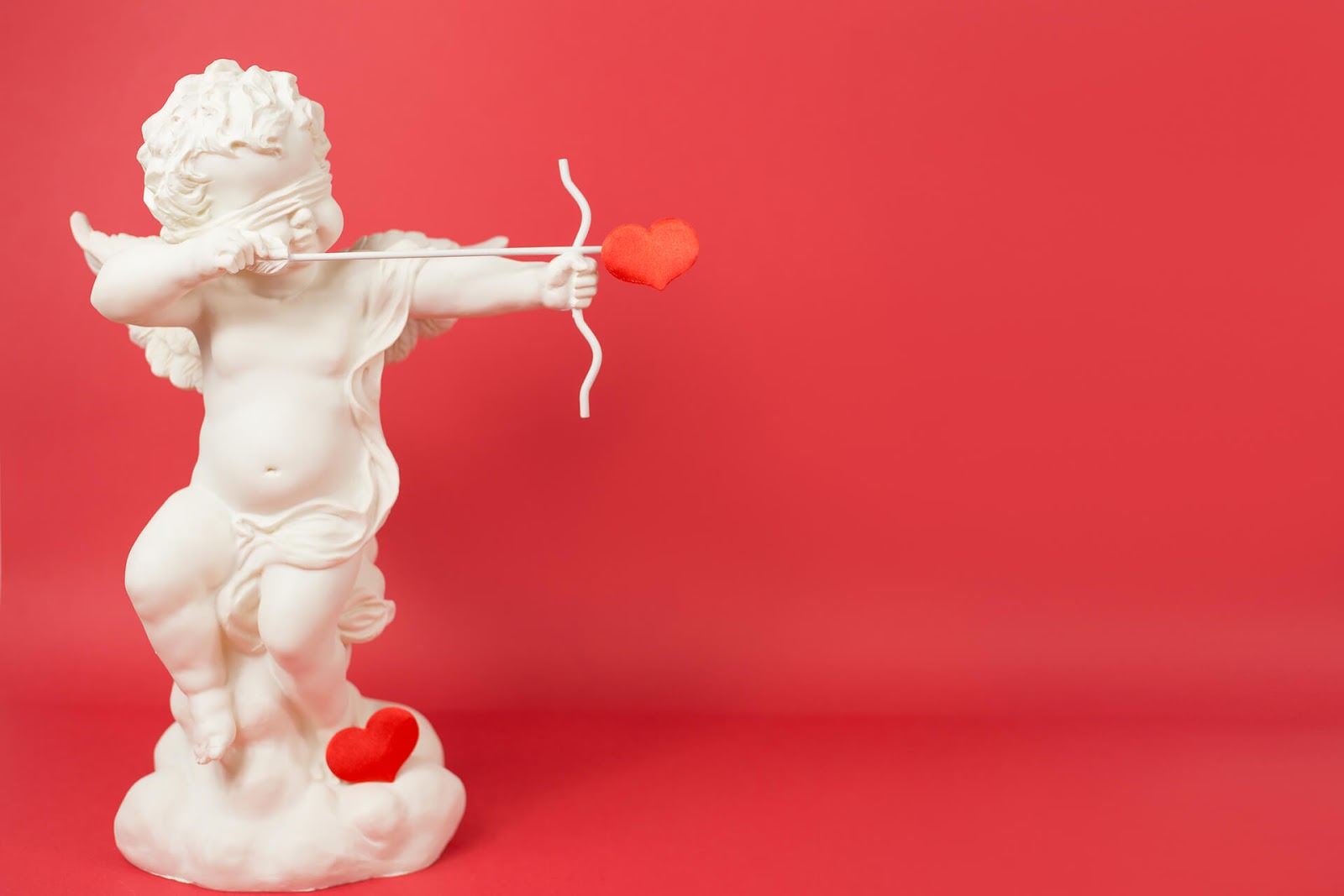Cupid shooting his arrow blindly