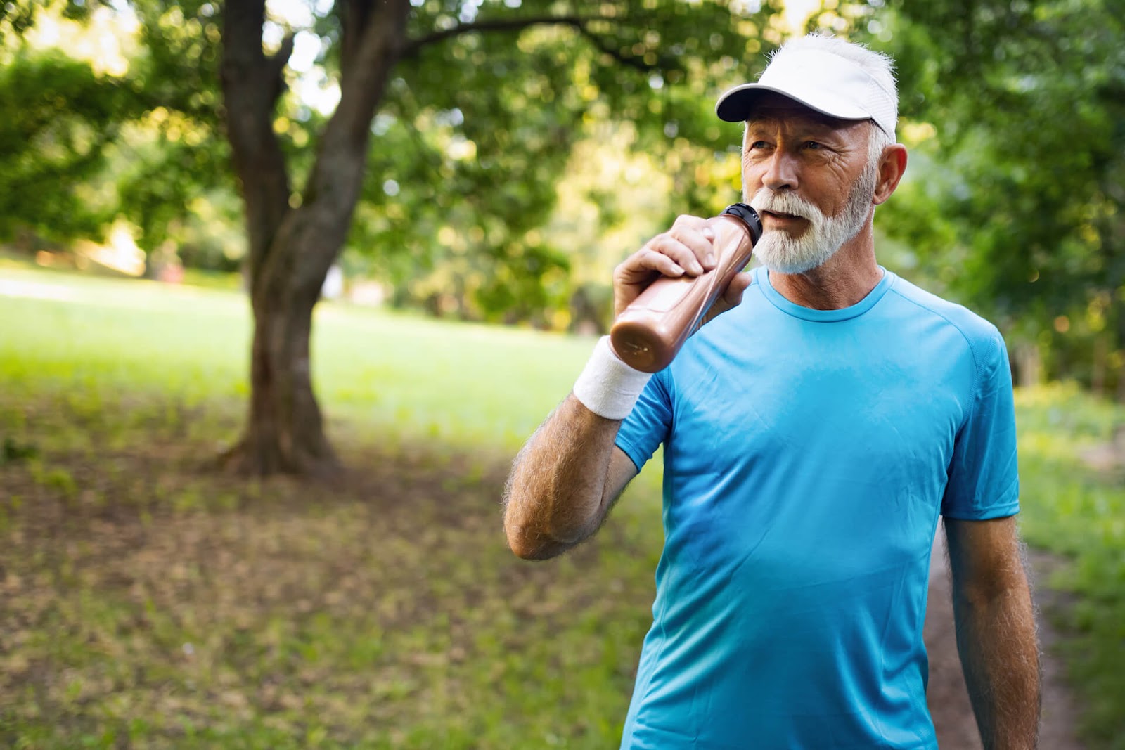 Grey-haired man enjoying a walk through the park
