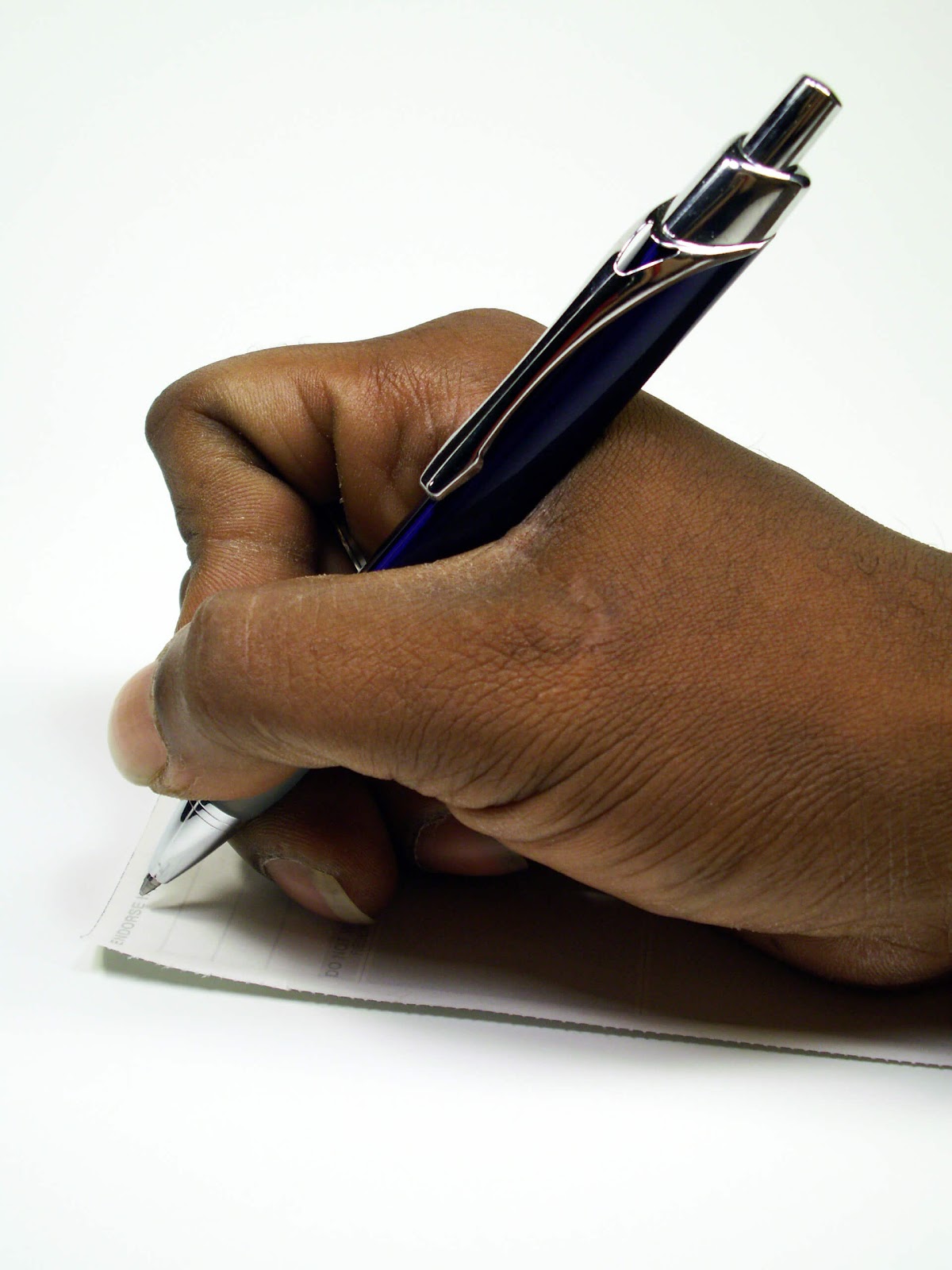 Close up of someone signing a paper