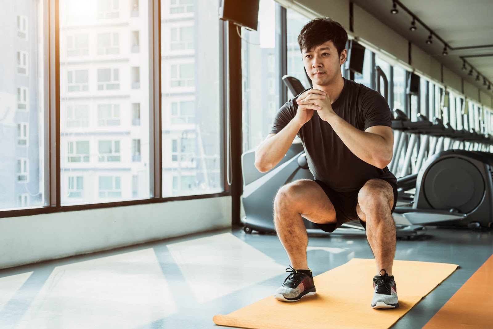 Man Squatting in a gym