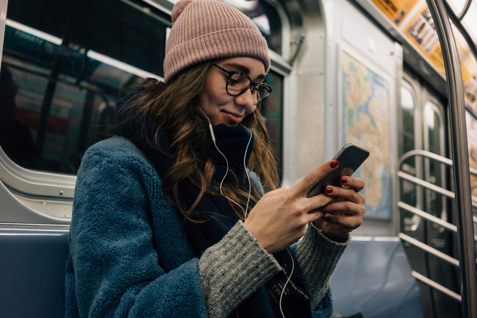 Woman on subway watching something on her phone