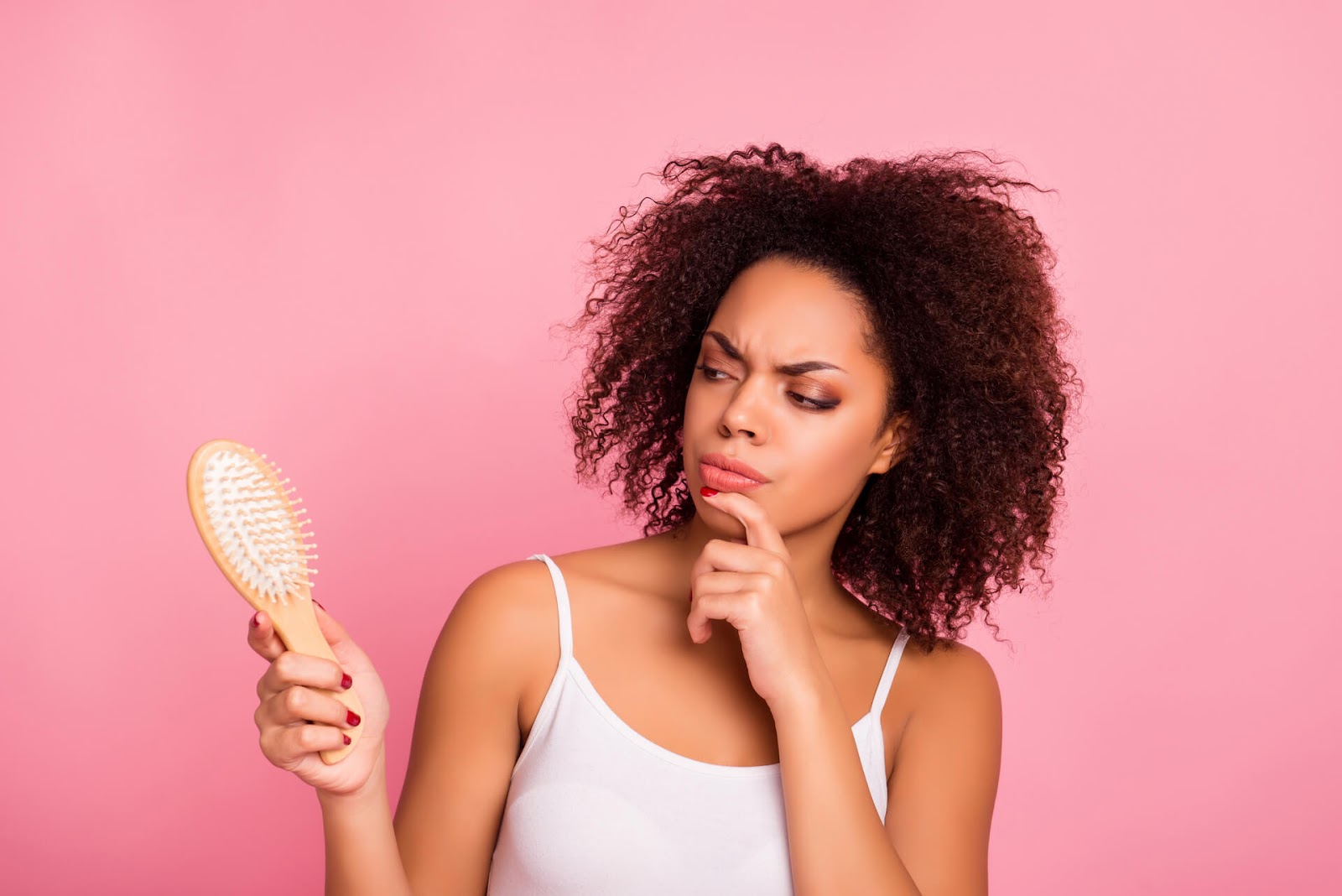 Woman looking suspiciously at her brush