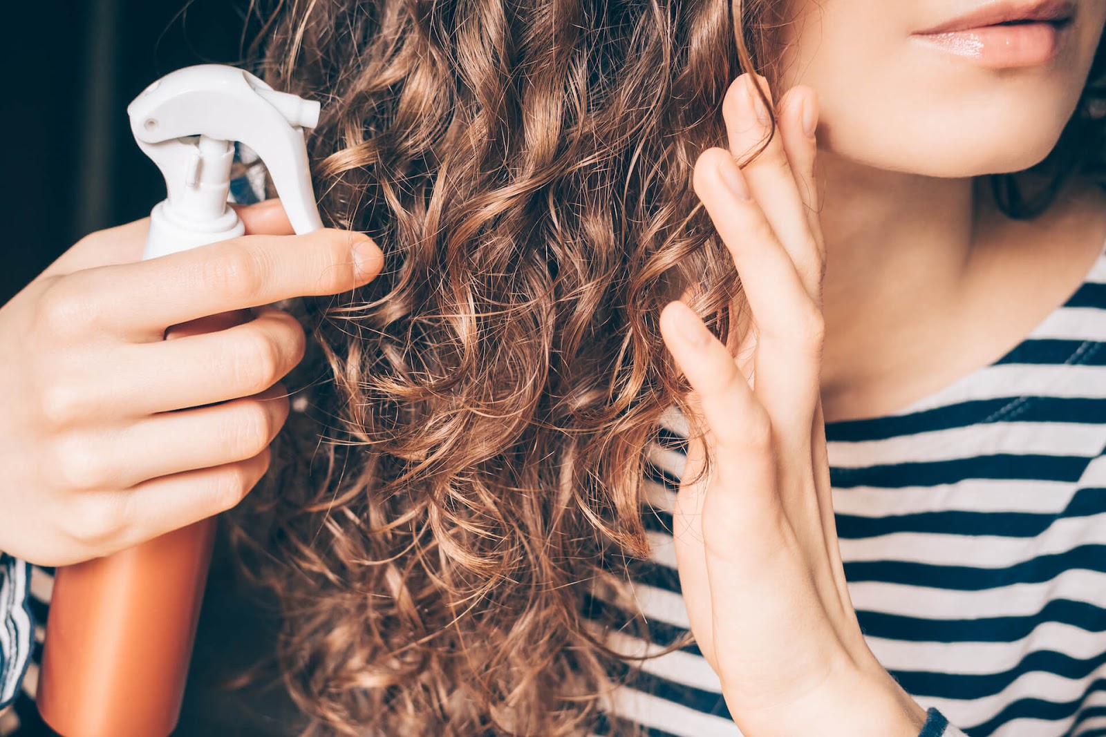Woman putting Curly Girl Method-approved products in her hair