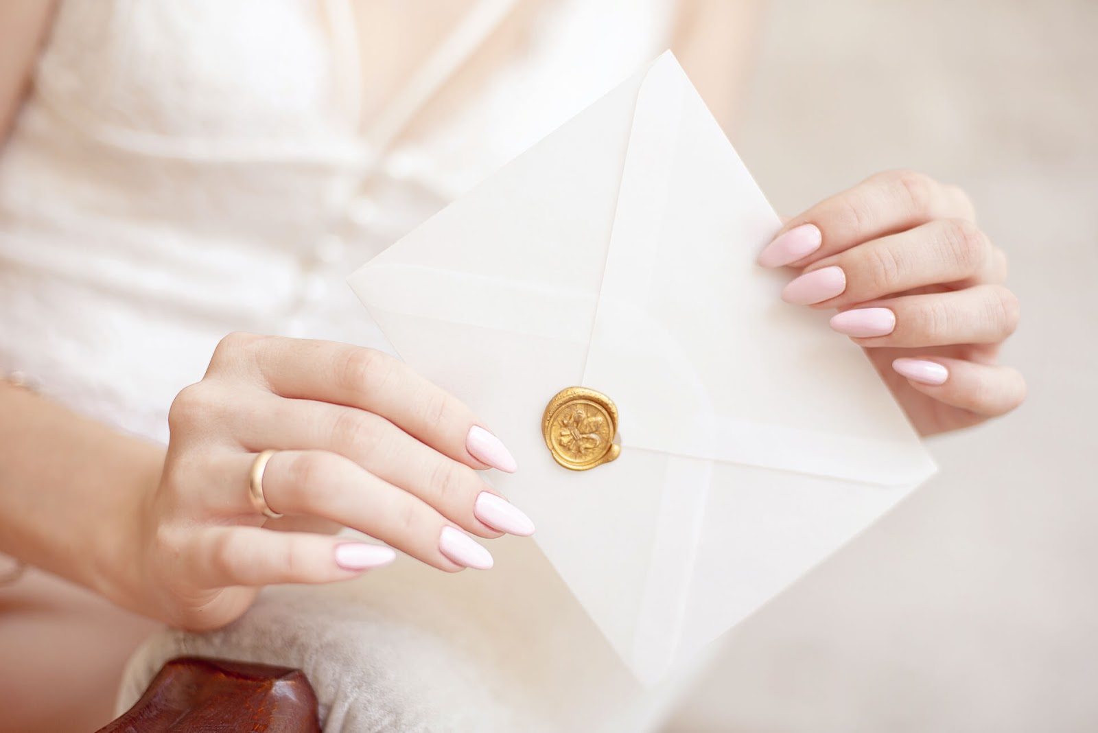 Hand holding an invitation