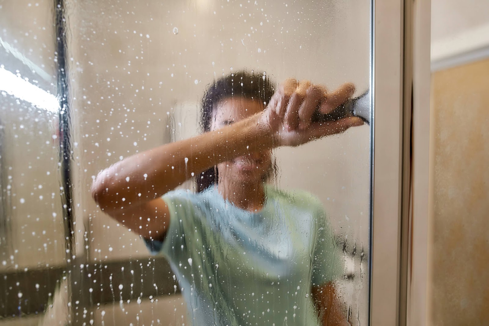 Woman squeegeeing her shower