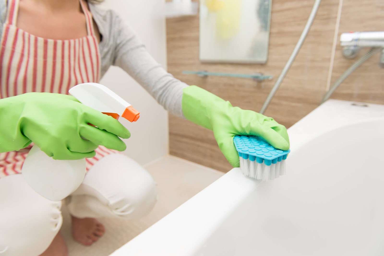 Woman scrubbing her bathtub