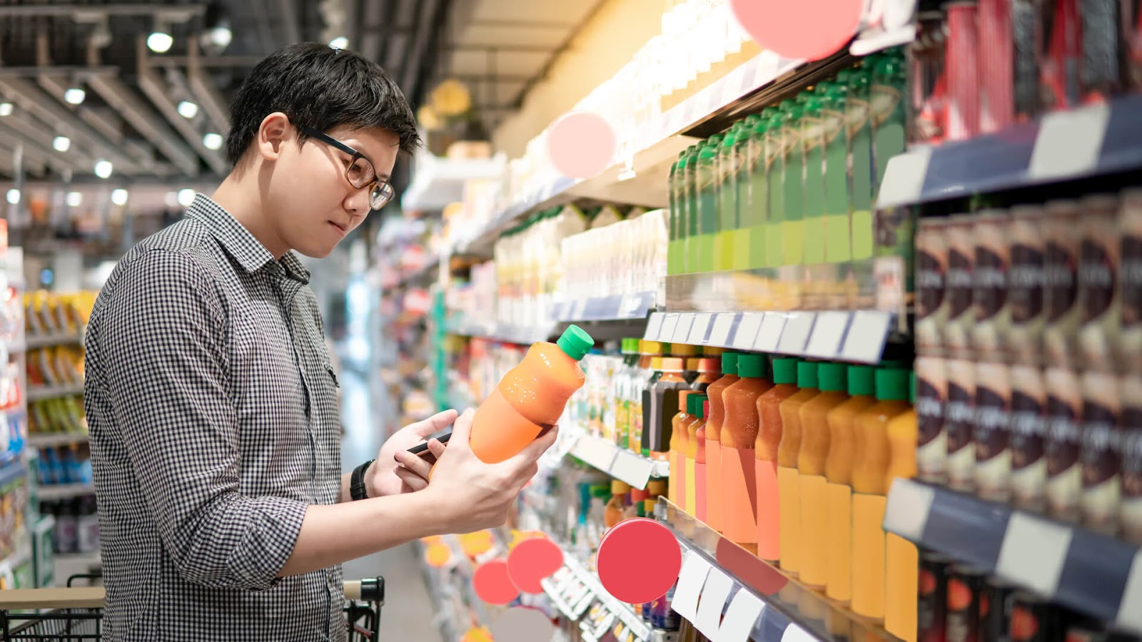 Man looking at the nutrition label on a juice bottle