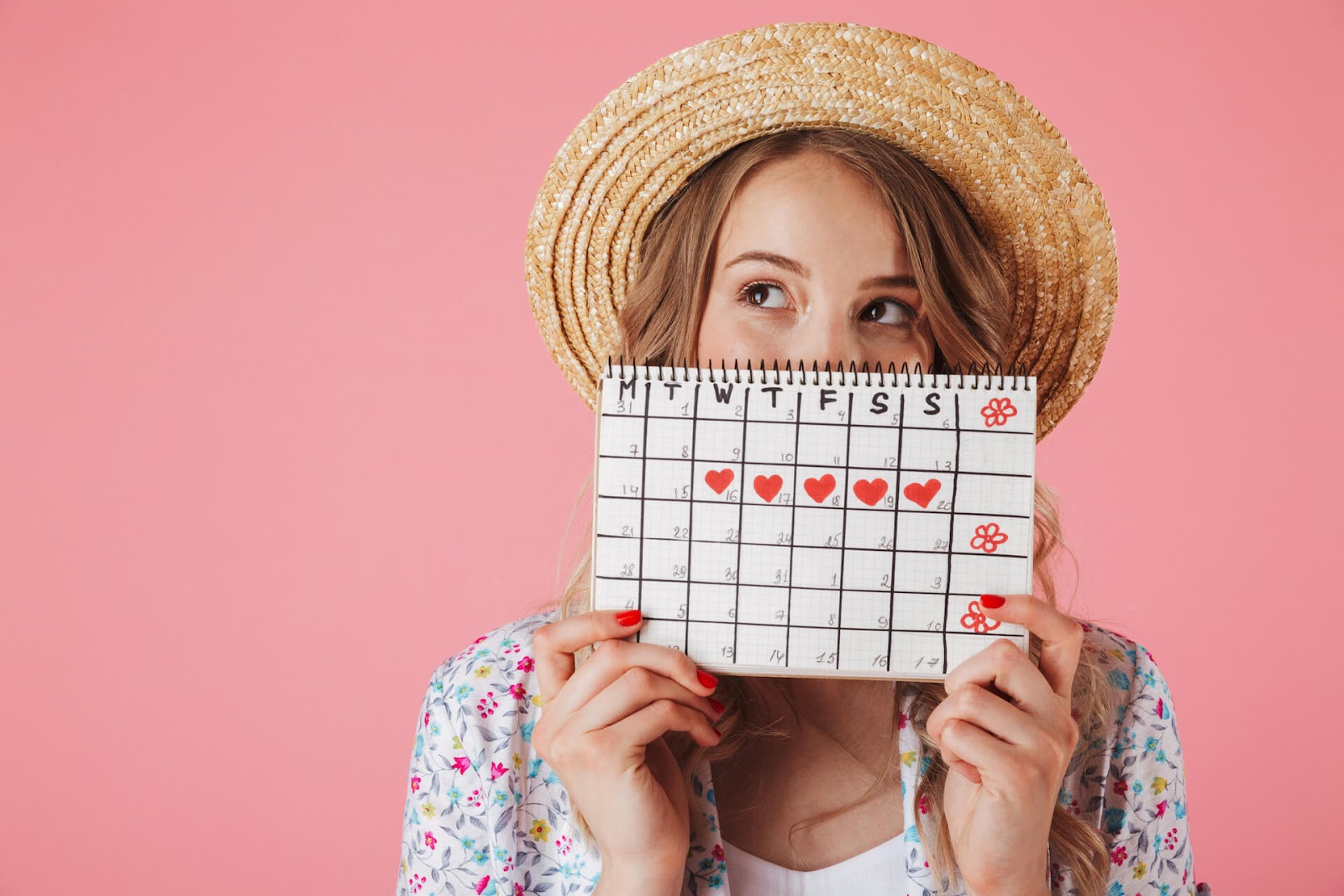 Woman holding up her menstrual calendar