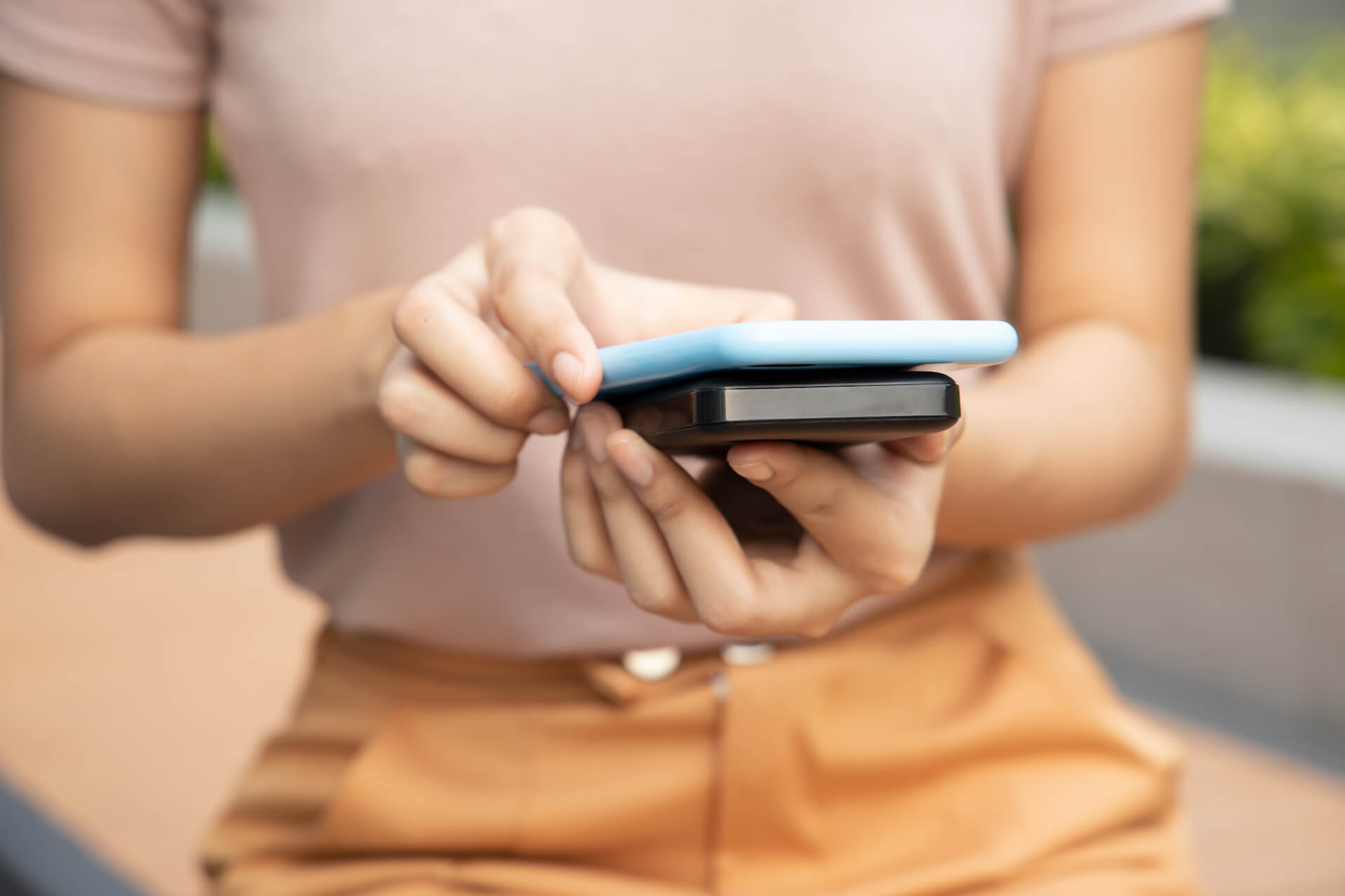 Woman holding her phone up to her battery pack