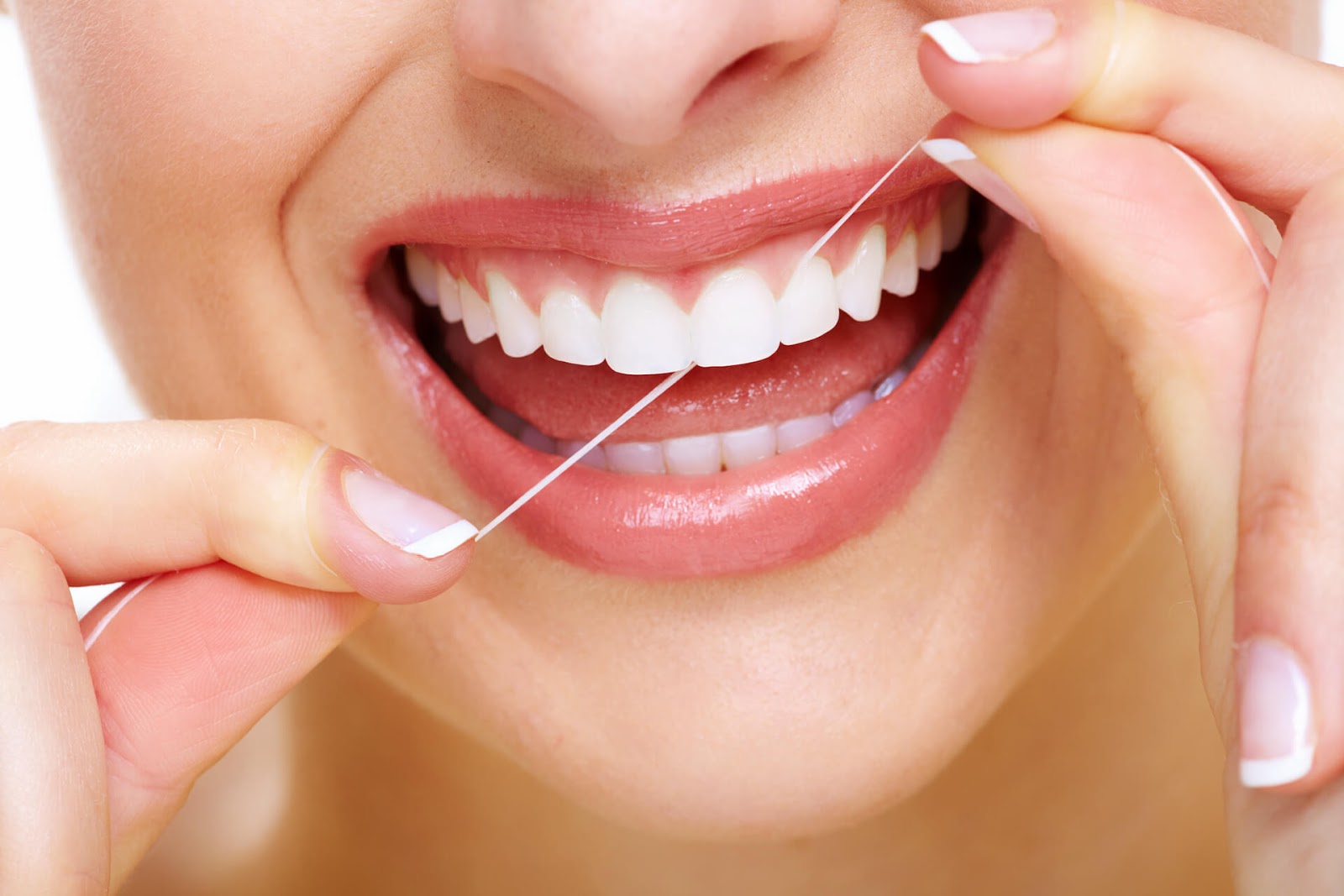 Close up of woman flossing her perfectly straight, white teeth