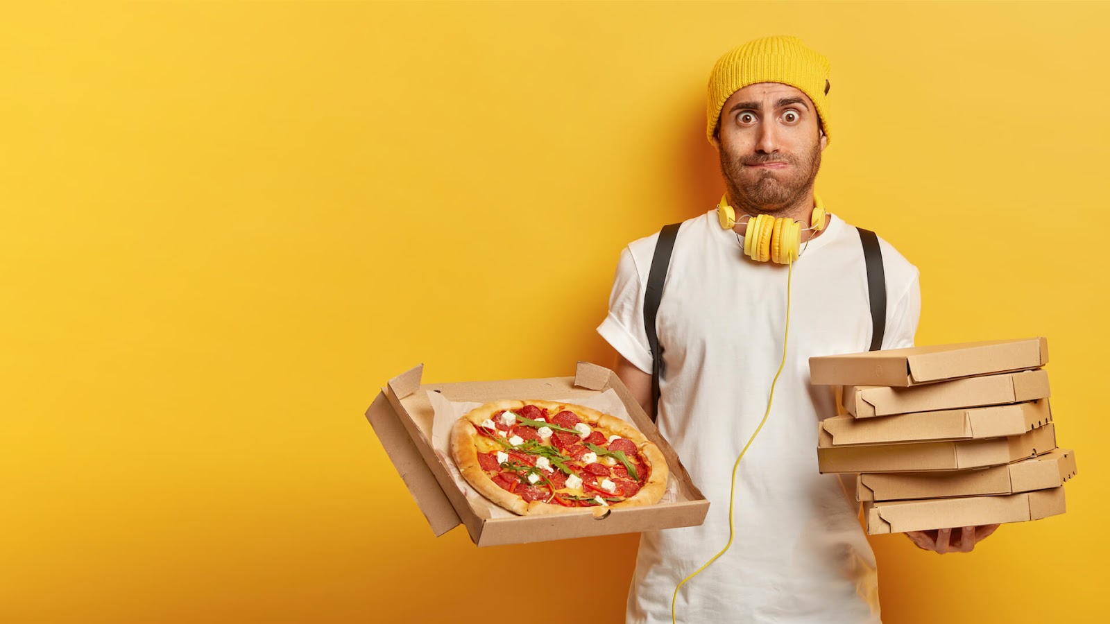 Man holding boxes of pizza