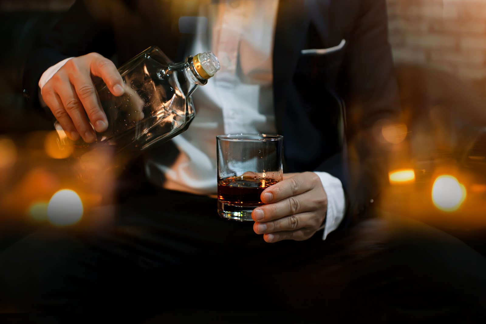 Classy man pouring himself some whiskey