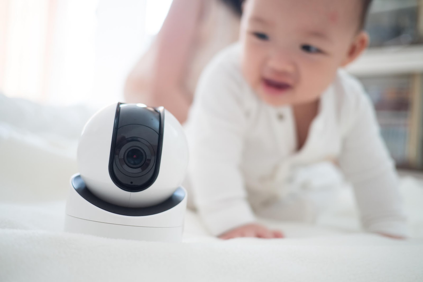 Baby crawling around by monitor