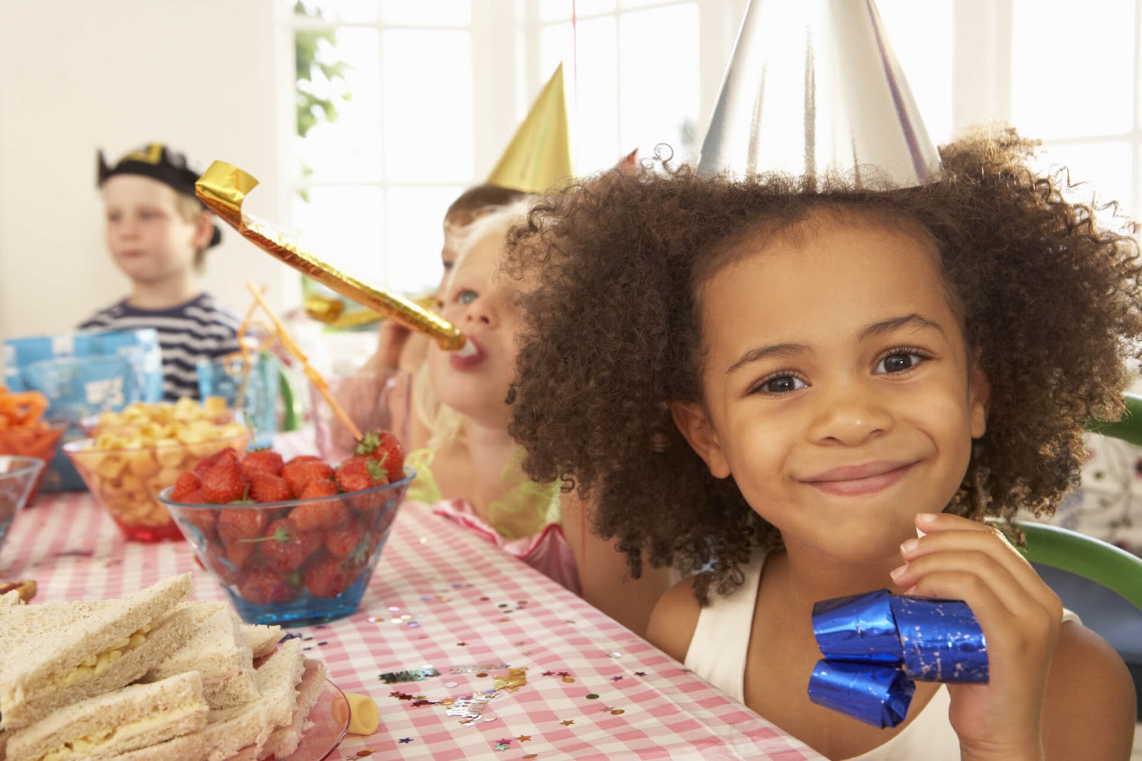 Girl looking at camera with friends and food in the background