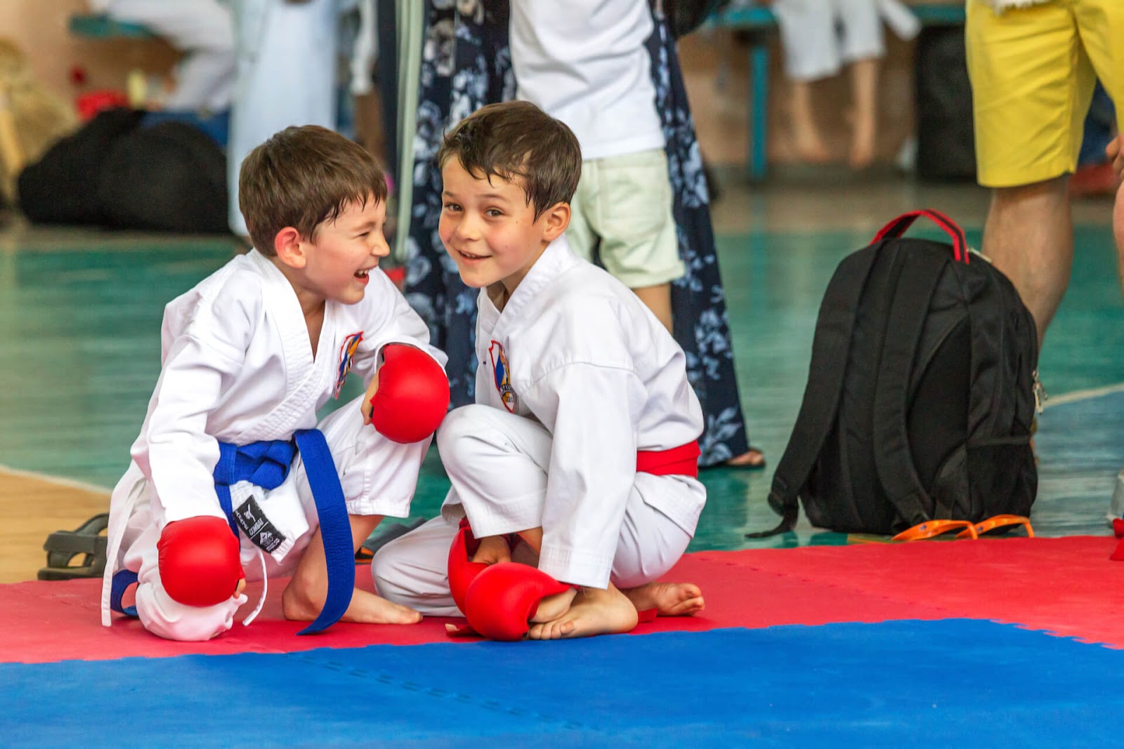 Two boys in karate gear laughing