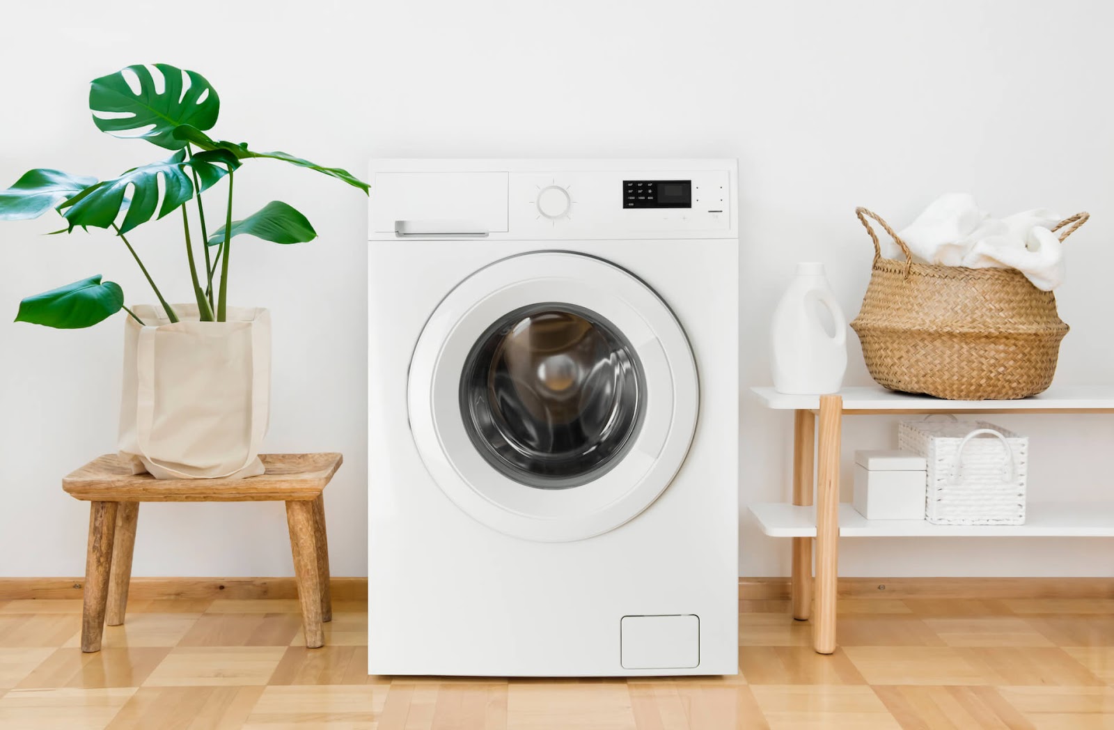 Classy washing machine with basket and fake plant next to it