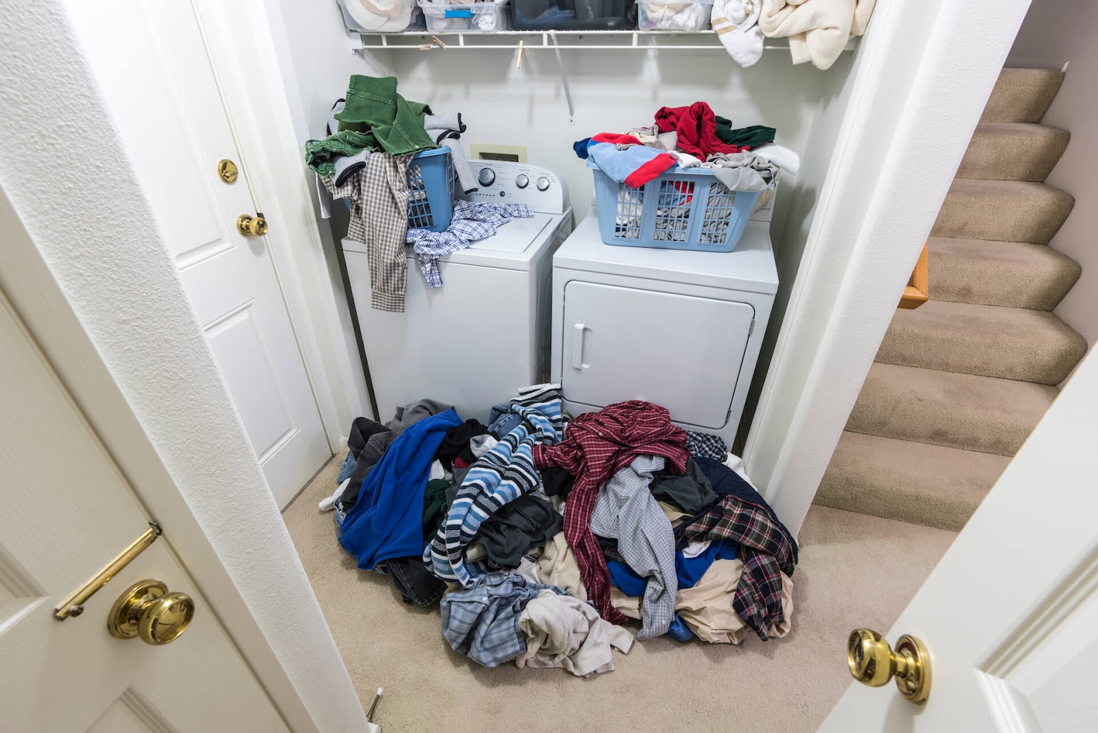 Piles of dirty laundry all over the washing area