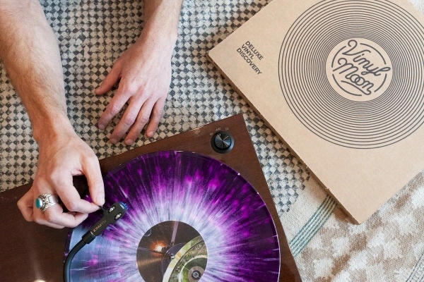 Hand putting a pretty cool looking record from Vinyl Moon on