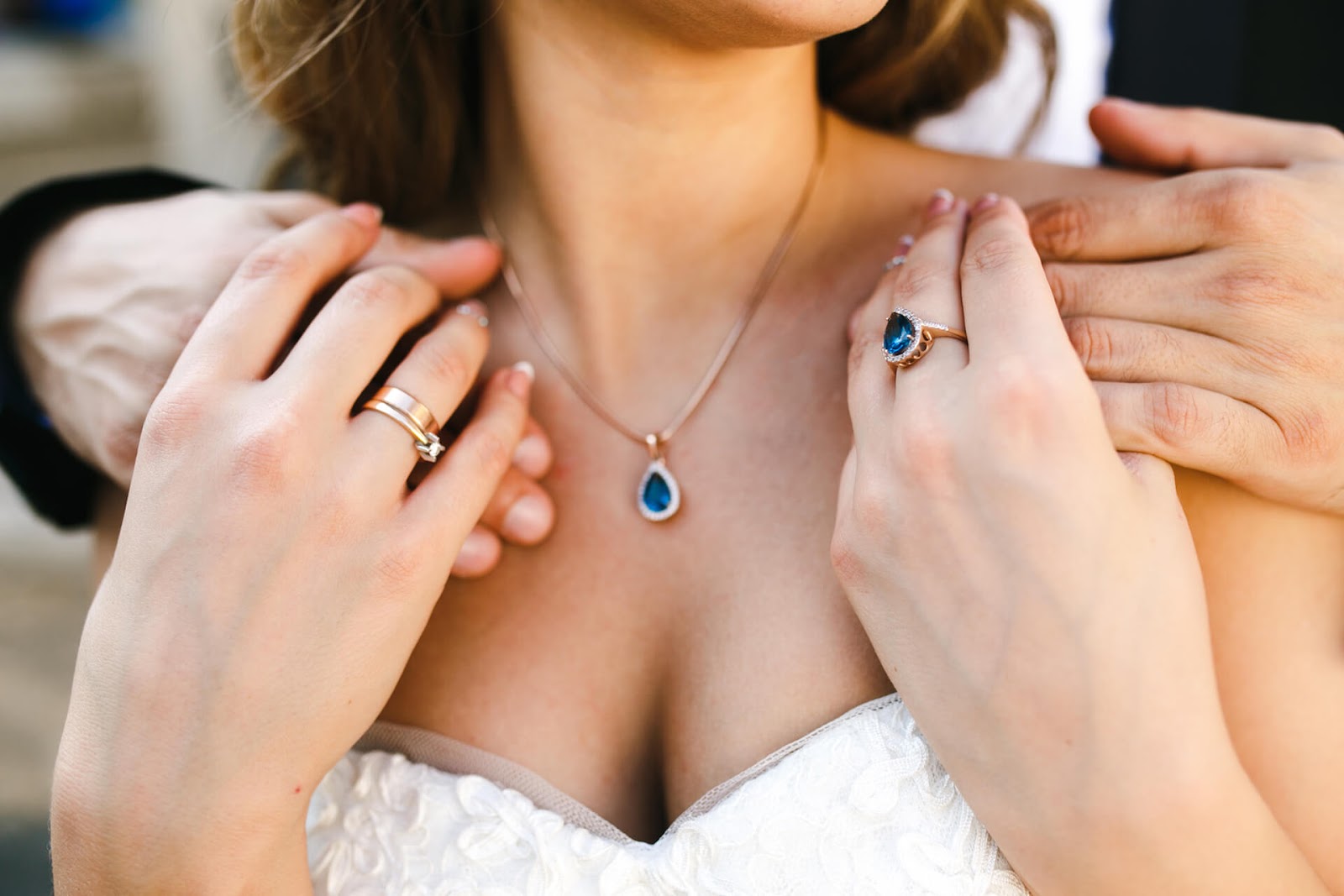 Woman wearing blue ring and necklace to accessorize
