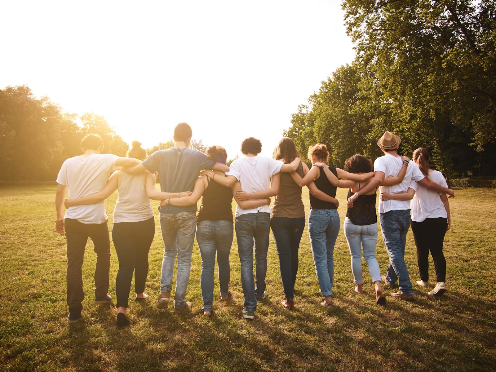 Group of friends waling with arms around each other