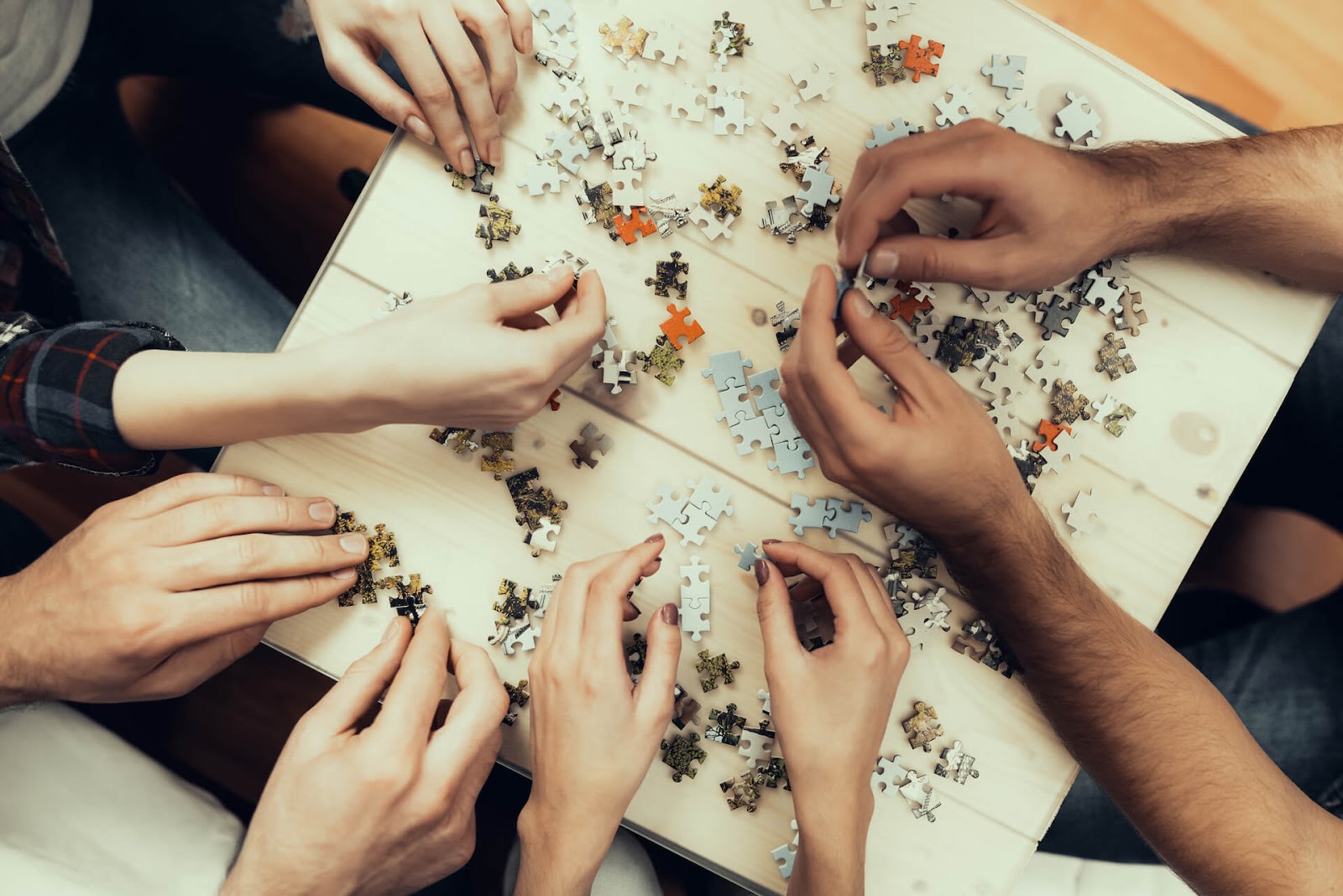 birds-eye view of friends putting a puzzle together