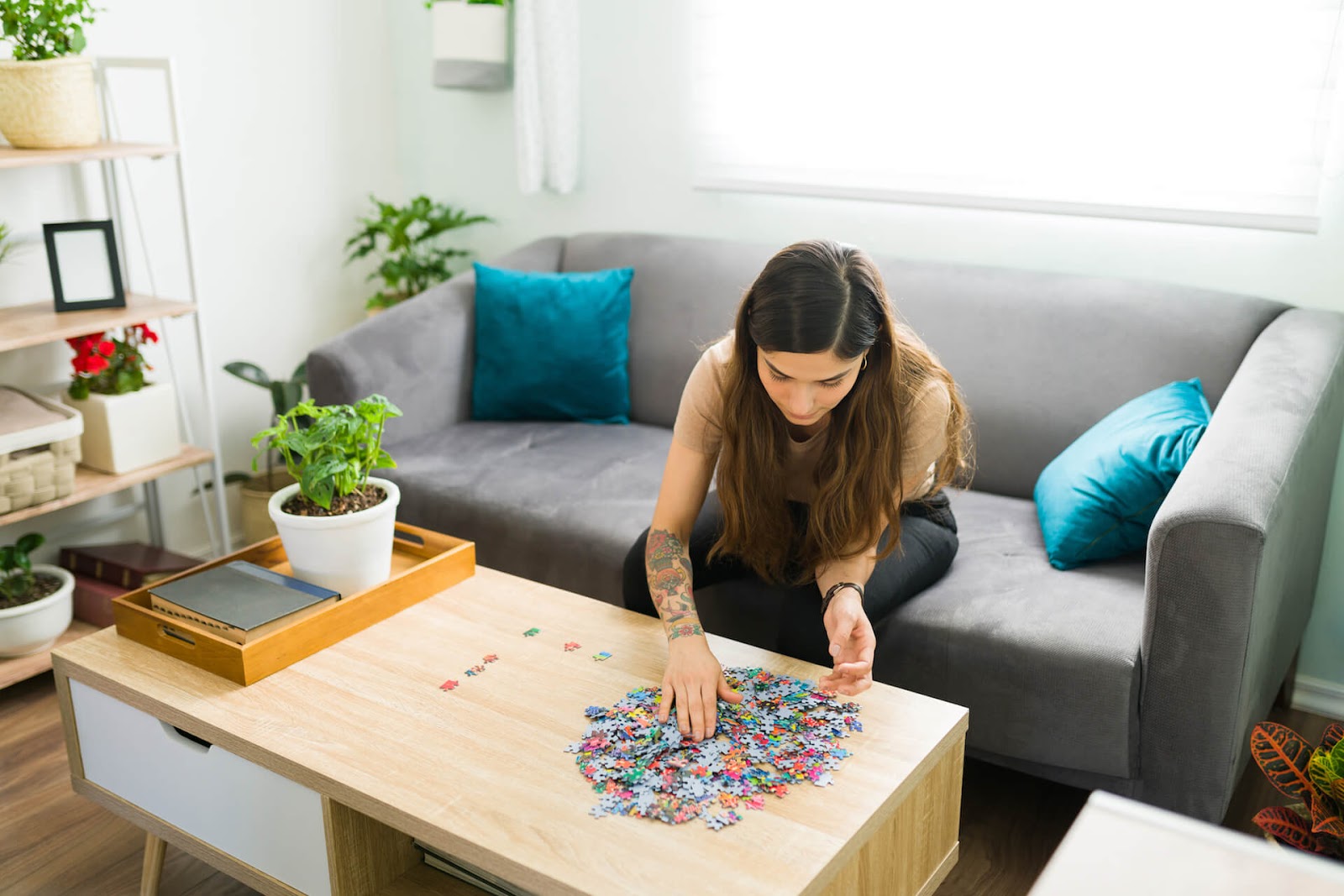 Woman putting together a puzzle on her coffee table