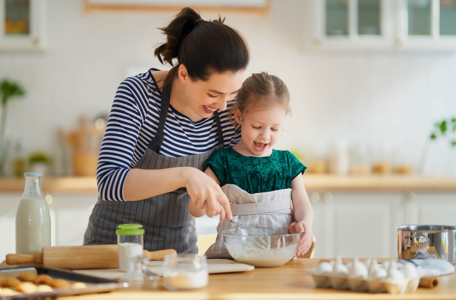 Mom and daughter baking together happily