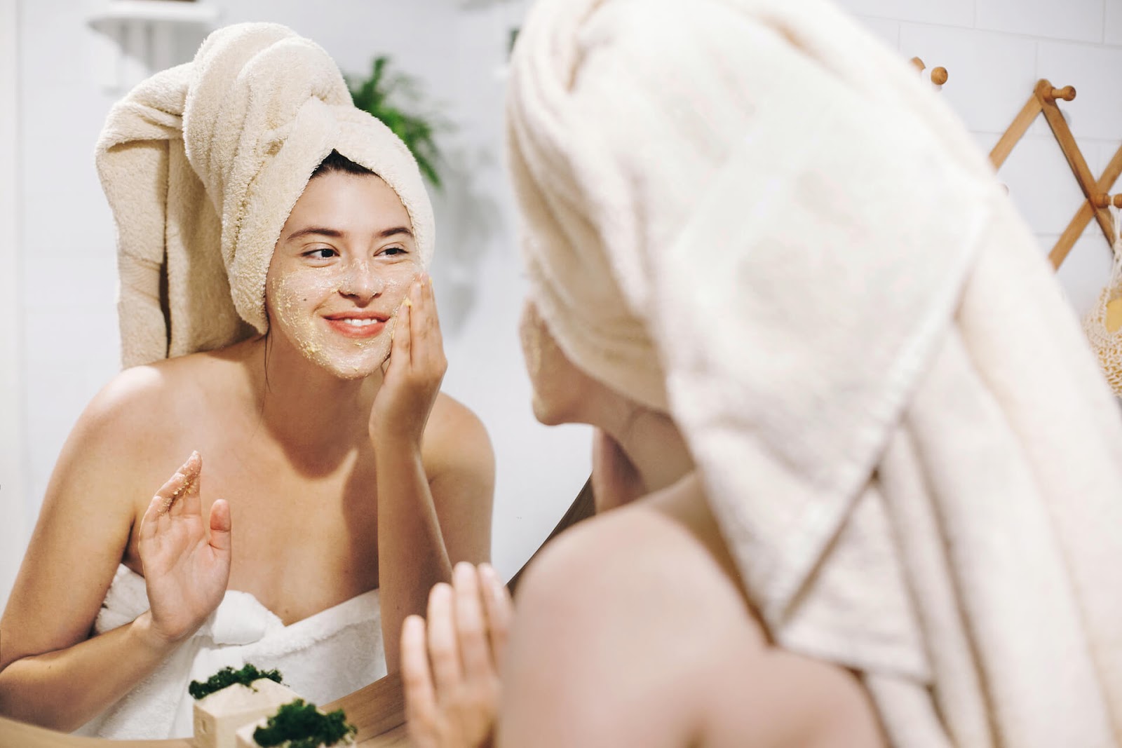 Woman putting a mask on her face