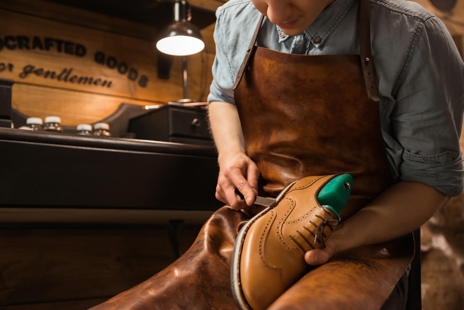 Man repairing nice leather shoes