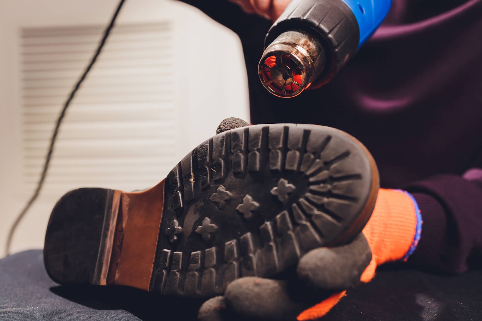 Someone heating up their shoes with a heat gun