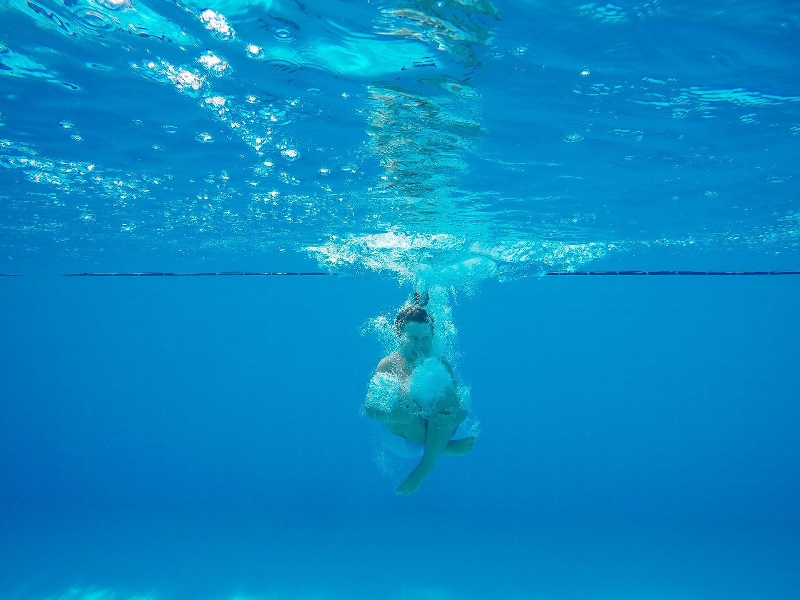 Woman cannon-balling into a pool