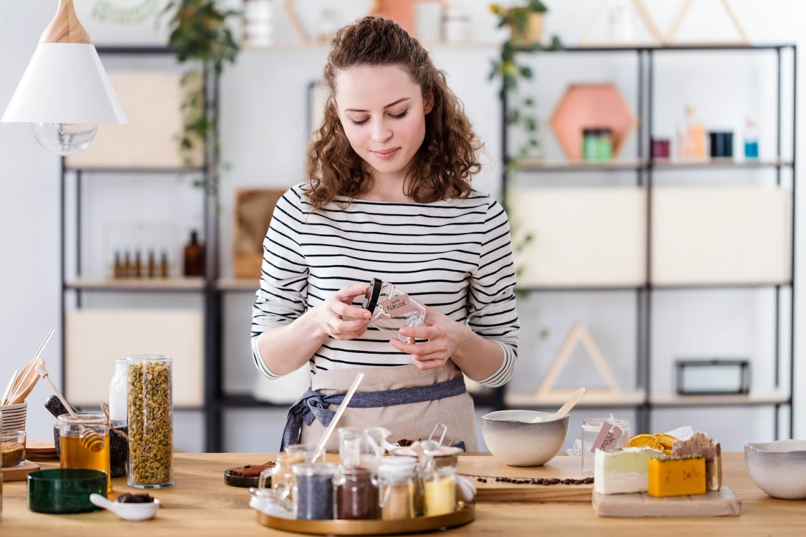 Woman making some homemade beauty products as a hobby in her living room