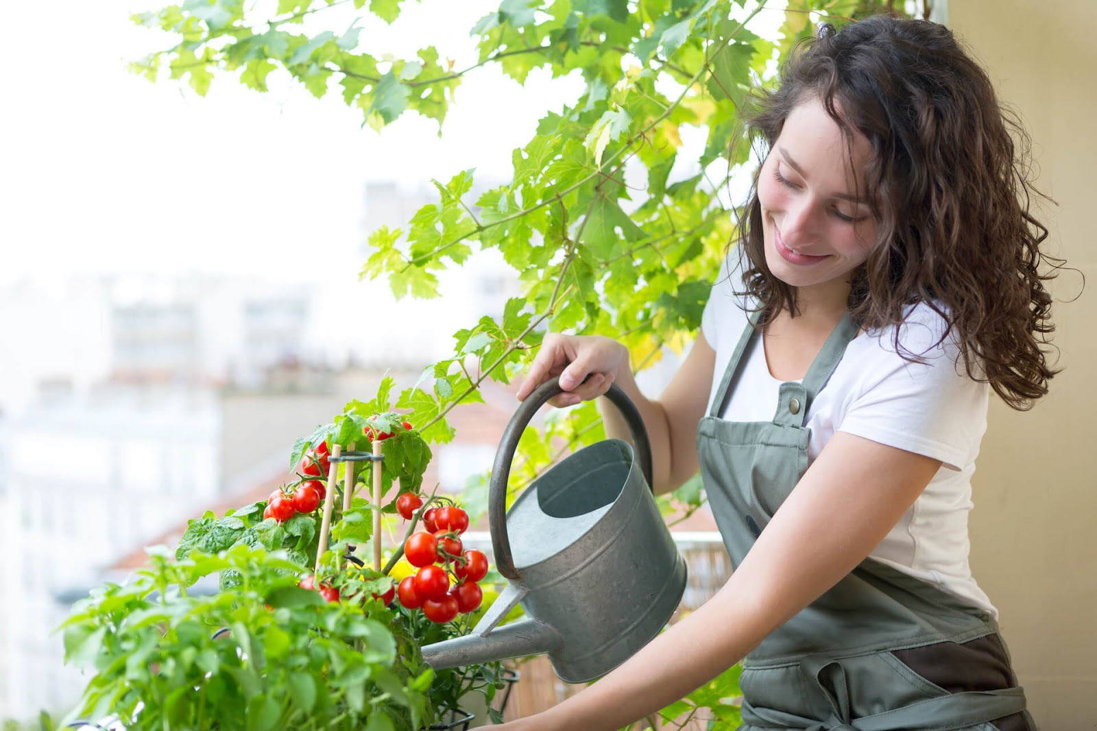 Woman watering her patio garden