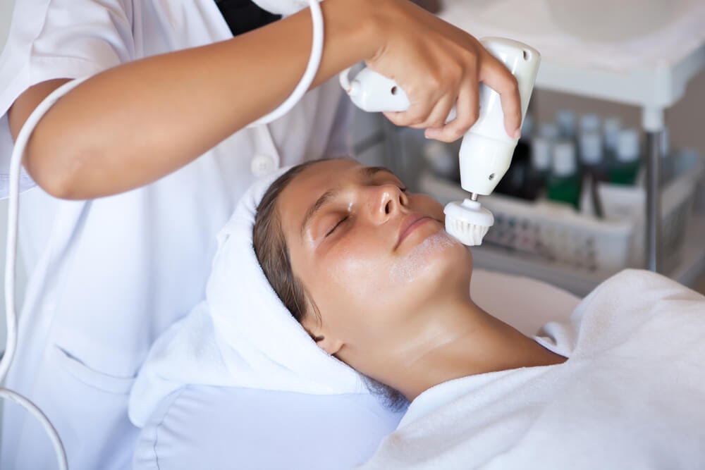 Woman getting an acne-fighting treatment done at a salon