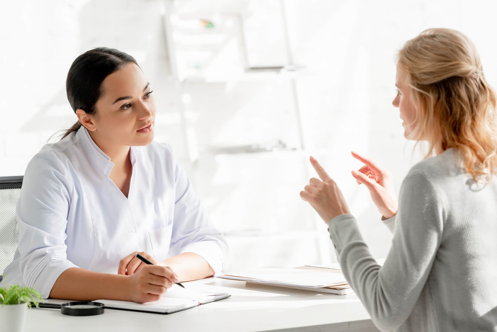 Woman chatting with her dermatologist