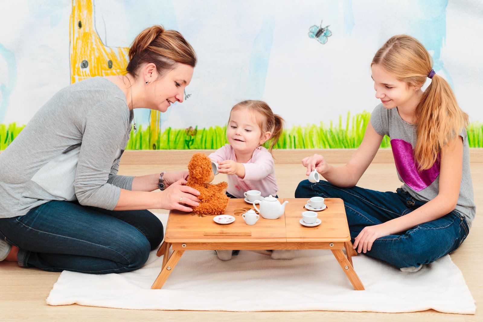 Mom and daughter tea party, complete with stuffed bear
