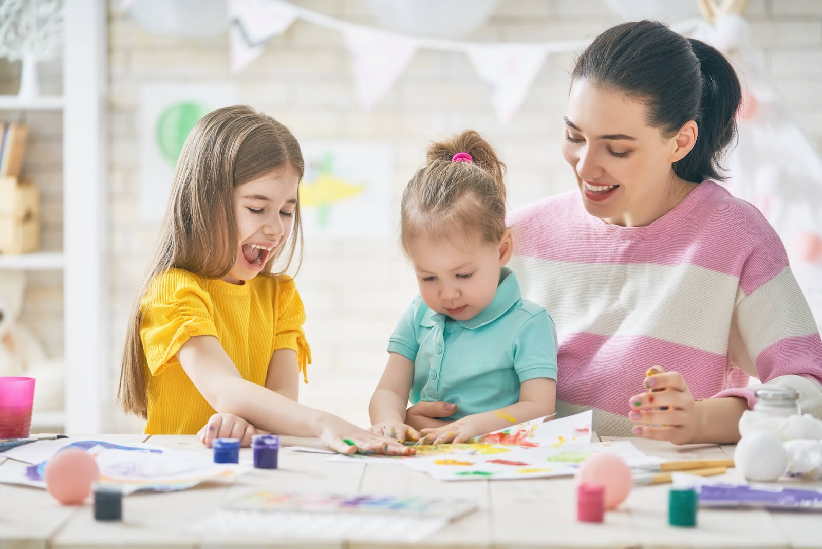 Mom and girls finger painting