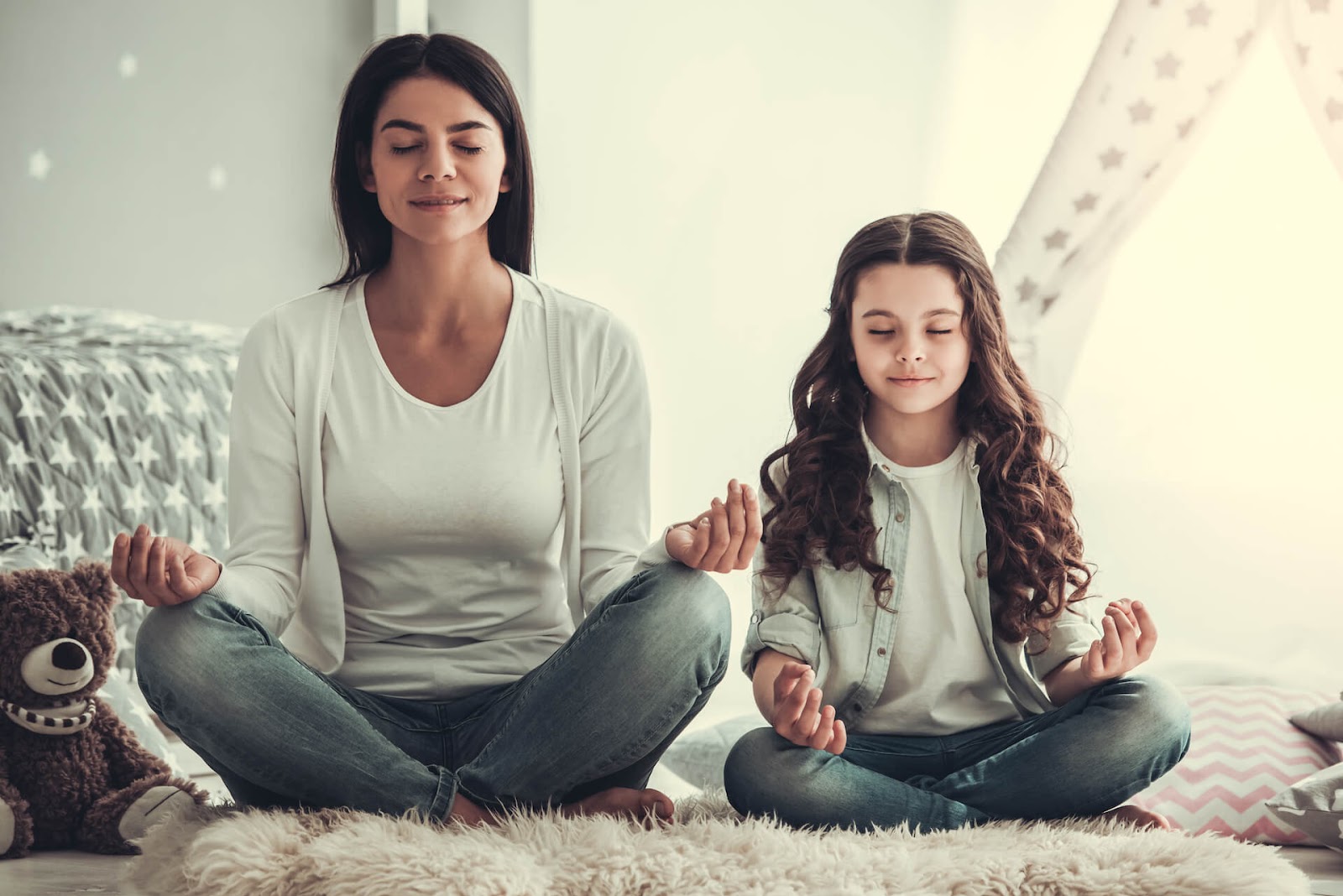Mom and daughter meditating together