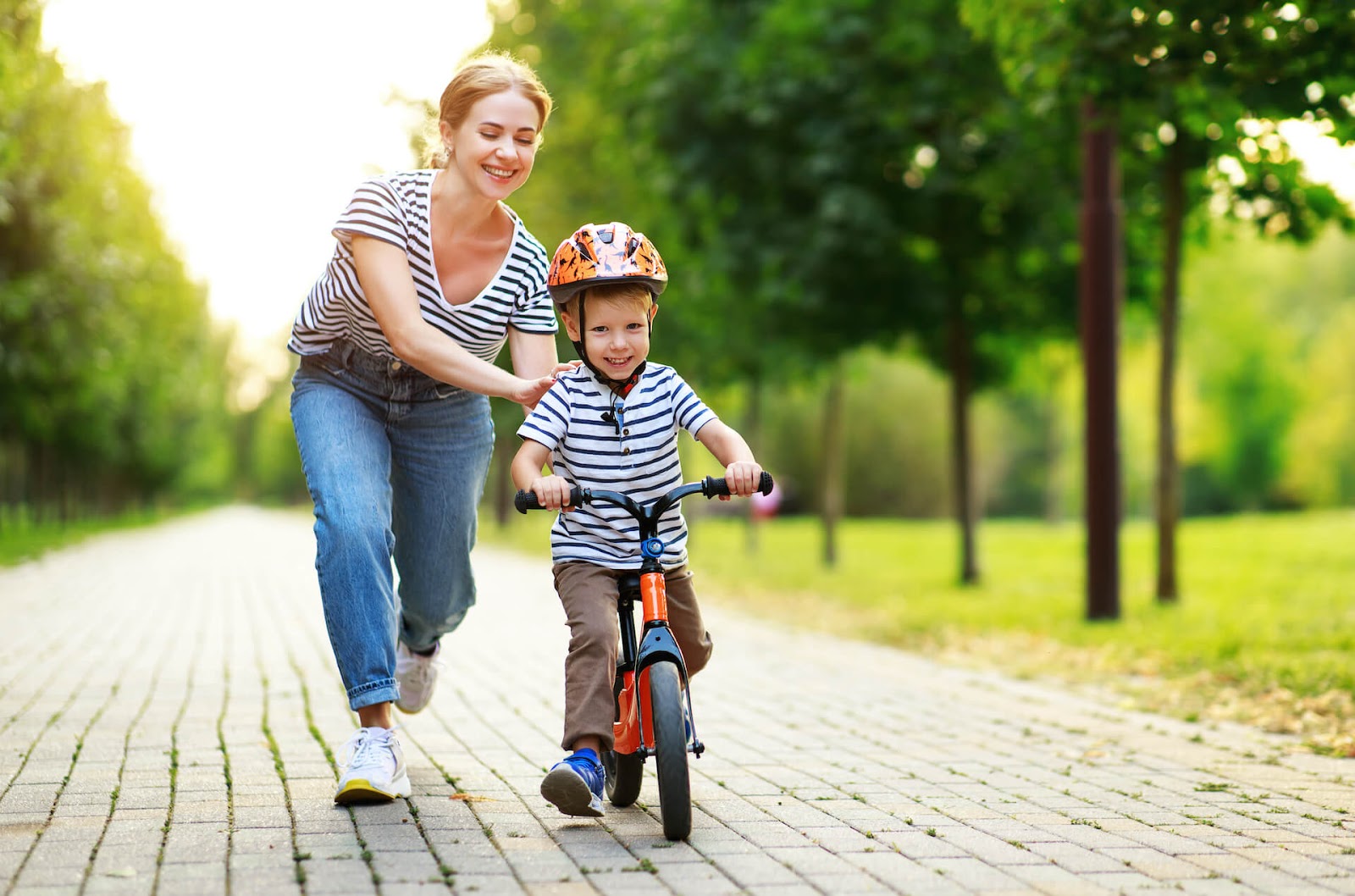 Mom teaching her son to ride a bike
